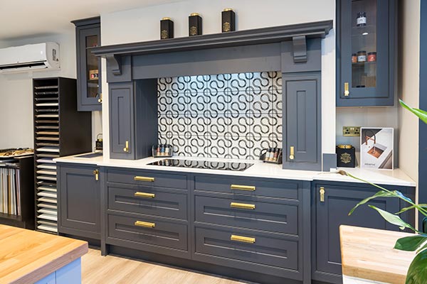 A1 Bathrooms & Kitchens. Painted kitchen with bespoke detailing and brass handles.